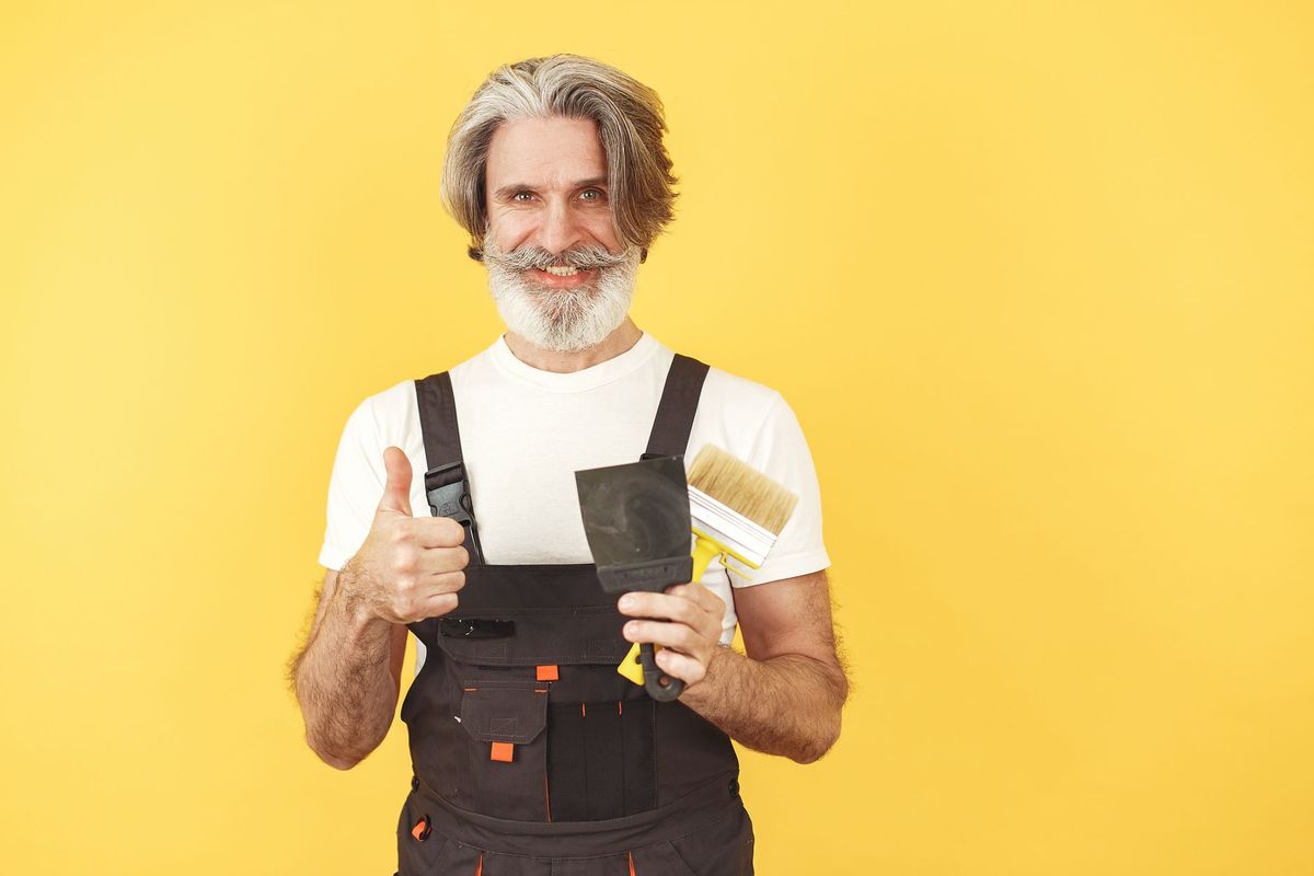 a friendly handyman with a tool belt working in a home